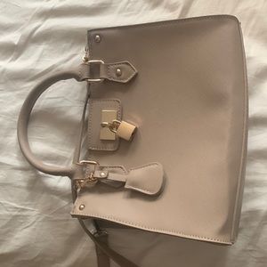 Woman's tan shoulder handbag with adjustable strap. Excellent condition